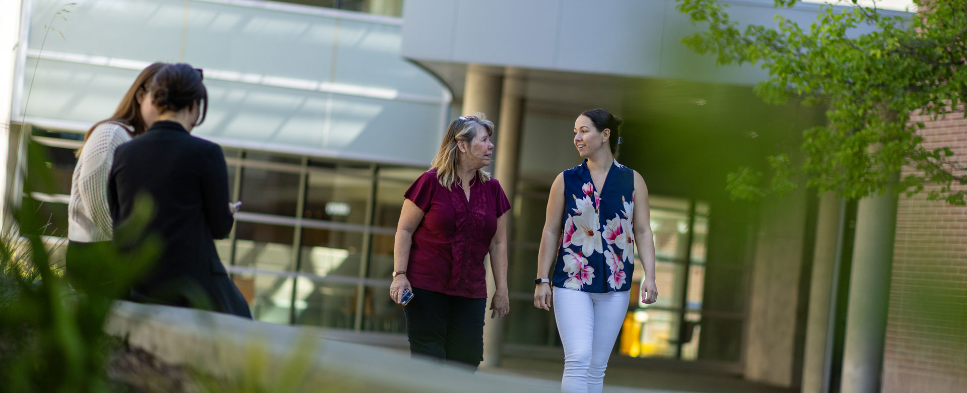 Staff members walking between buildings at UBC Okanagan.